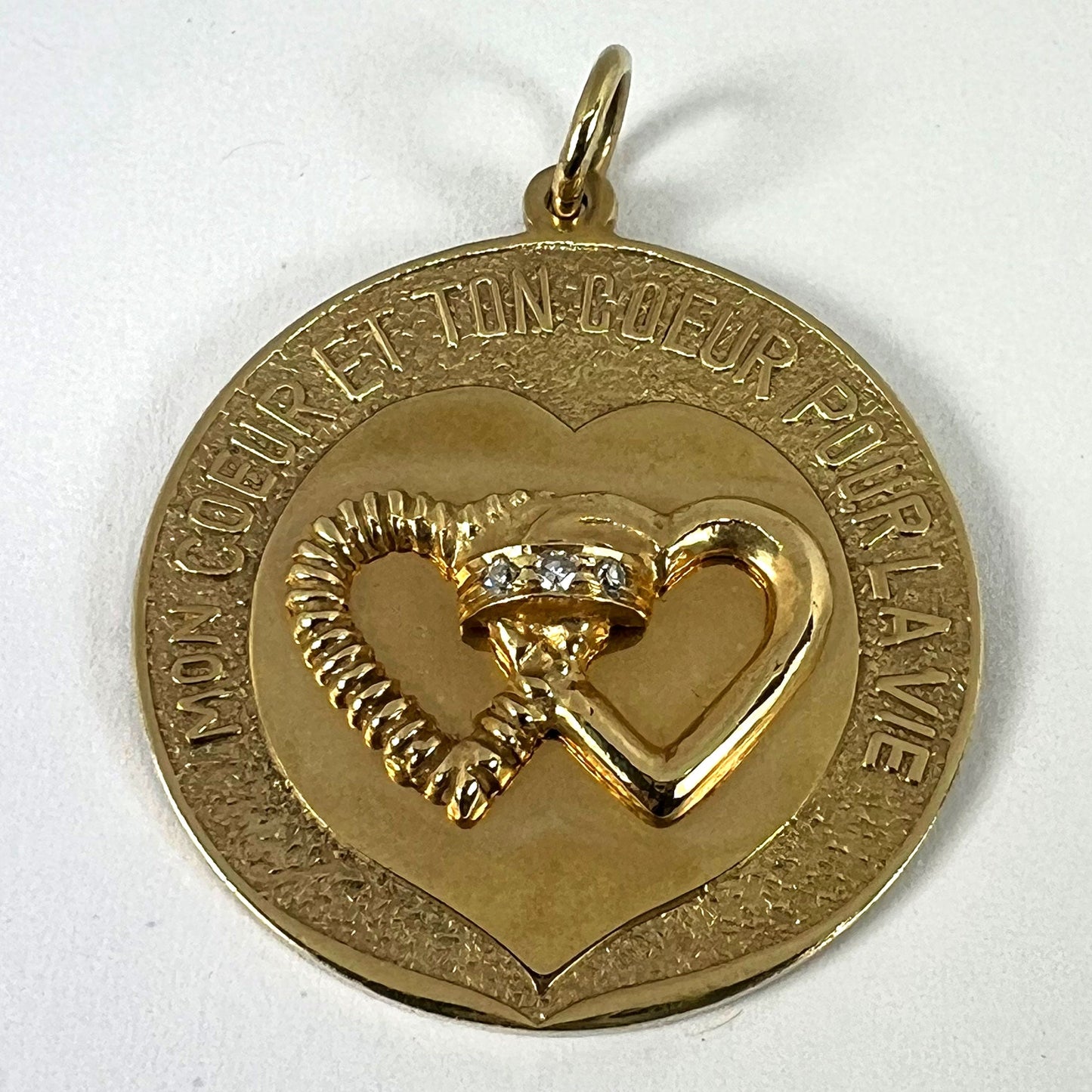 A round yellow gold love heart diamond pendant engraved MON COEUR ET TON COEUR POUR LA VIE