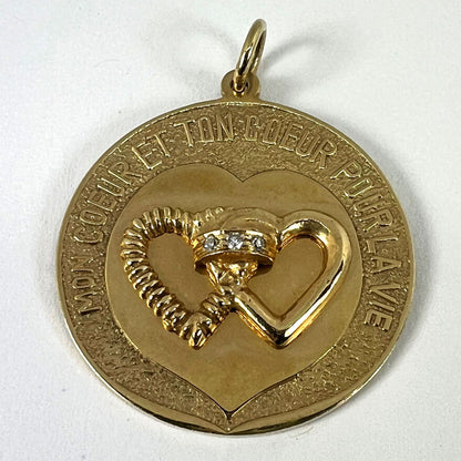 A round yellow gold love heart diamond pendant engraved MON COEUR ET TON COEUR POUR LA VIE
