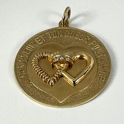 A round yellow gold love heart diamond pendant engraved MON COEUR ET TON COEUR POUR LA VIE