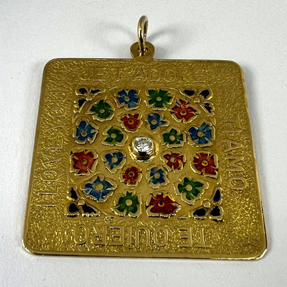 A square shaped yellow gold pendant with enamelled flowers and a central diamond, with text reading JE T'ADORE, TI AMO, TE QUIERO, I LOVE YOU