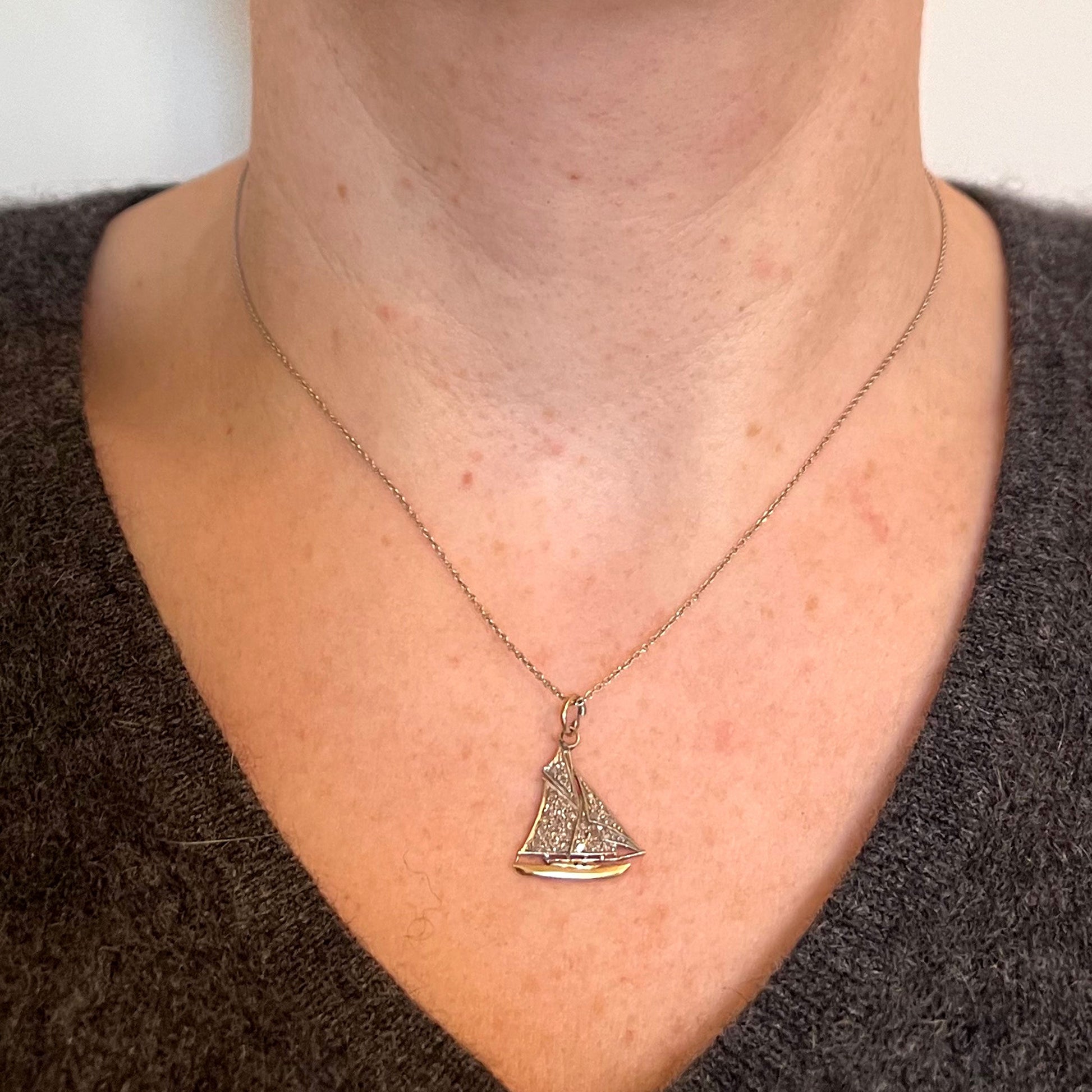 A diamond set yacht boat pendant, modelled on a gold chain