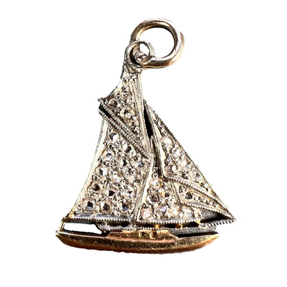 A diamond set yacht boat pendant, on a white background