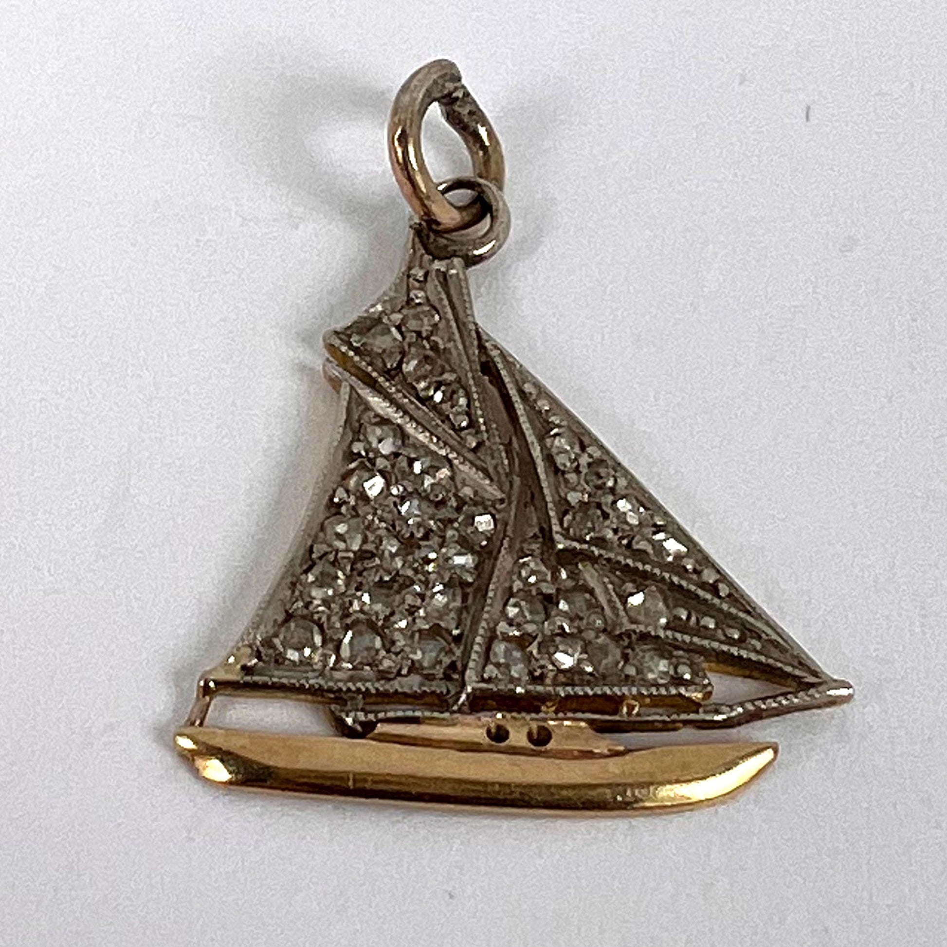 A diamond set yacht boat pendant, on a white background