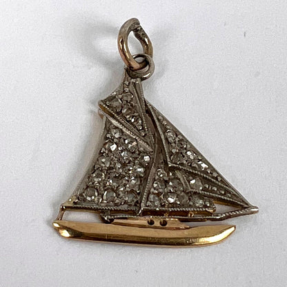 A diamond set yacht boat pendant, on a white background