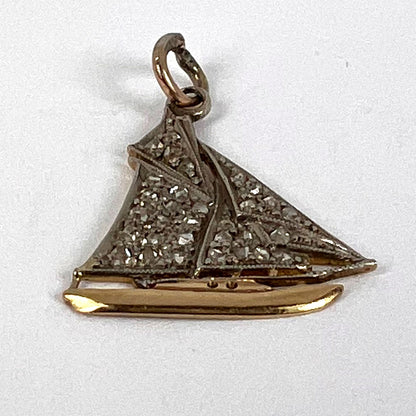 A diamond set yacht boat pendant, on a white background