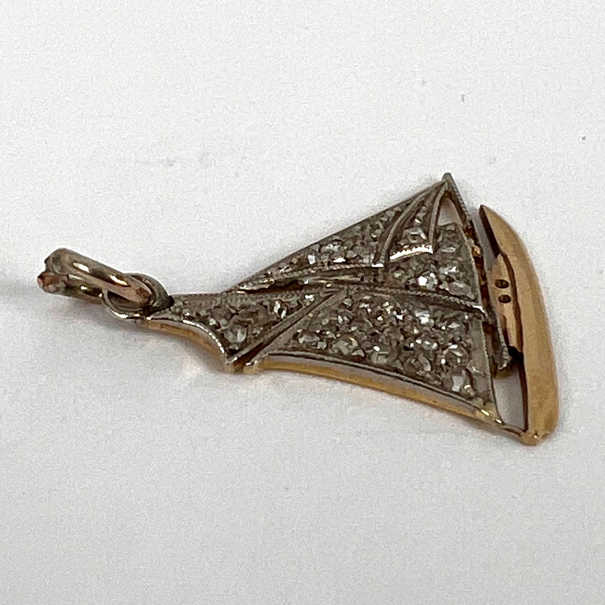 A diamond set yacht boat pendant, on a white background