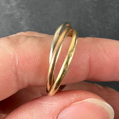 A tri-colour gold Russian wedding ring, modelled on a finger