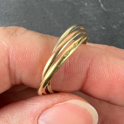 A tri-colour gold Russian wedding ring, modelled on a finger