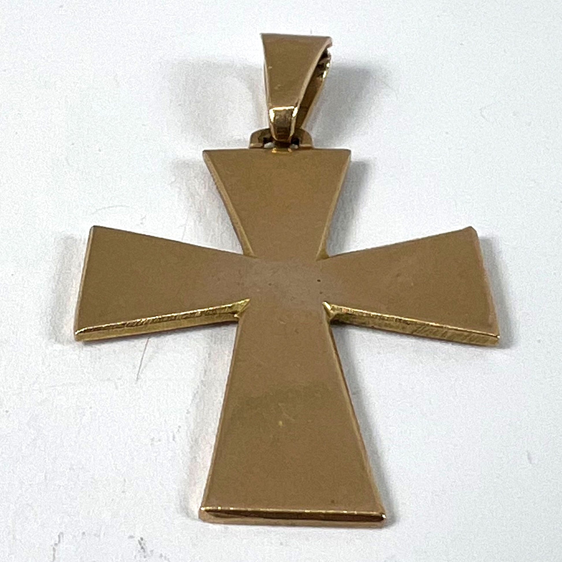 A plain gold cross pendant, on a white background