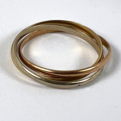 A tri-colour gold Russian wedding ring, on a white background