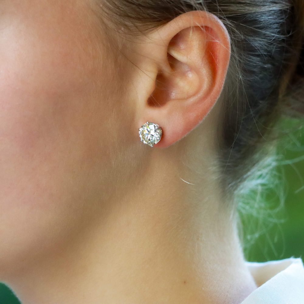 Solitaire certified diamond stud earrings set in gold,