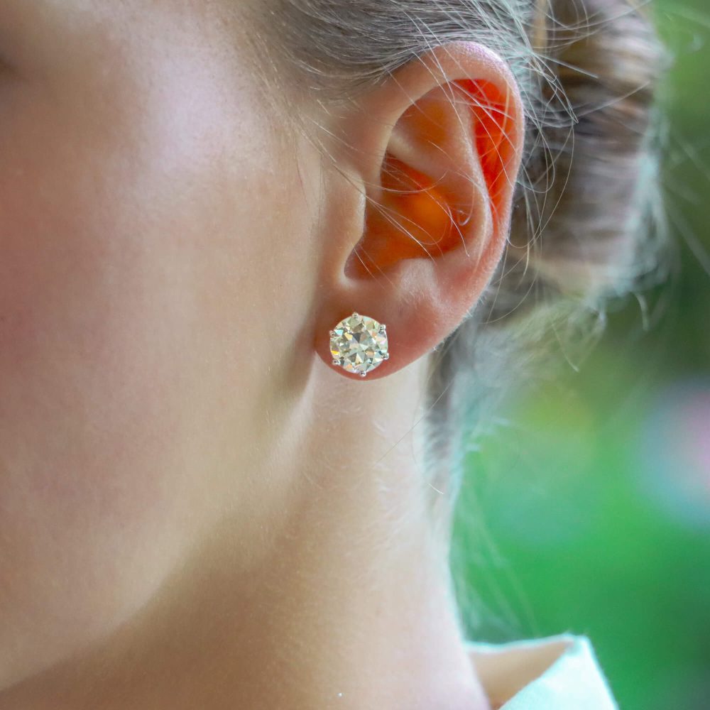 Solitaire certified diamond stud earrings set in gold,