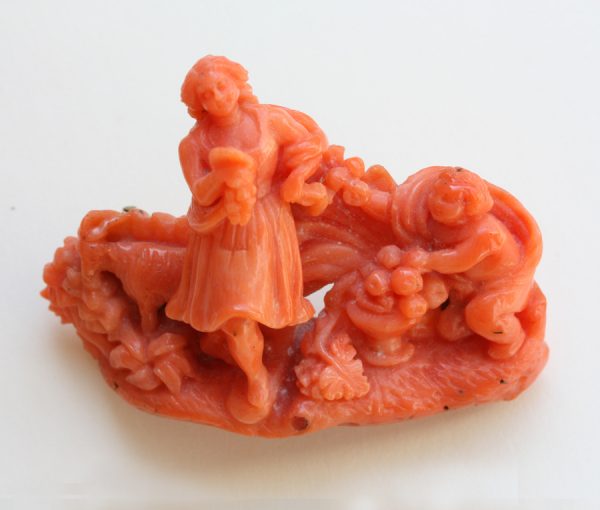 18th Century Carved Coral Brooch; A carved coral brooch featuring a sculpture of a bucolic scene praising country life. Italy, 18th century.
