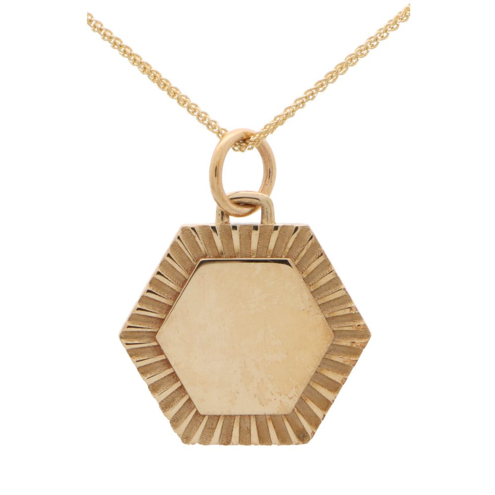 Hexagonal 9 carat yellow gold disc pendant.