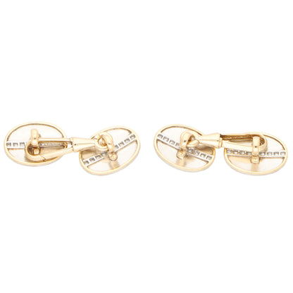 A pair of yellow gold oval cufflinks, on a white background