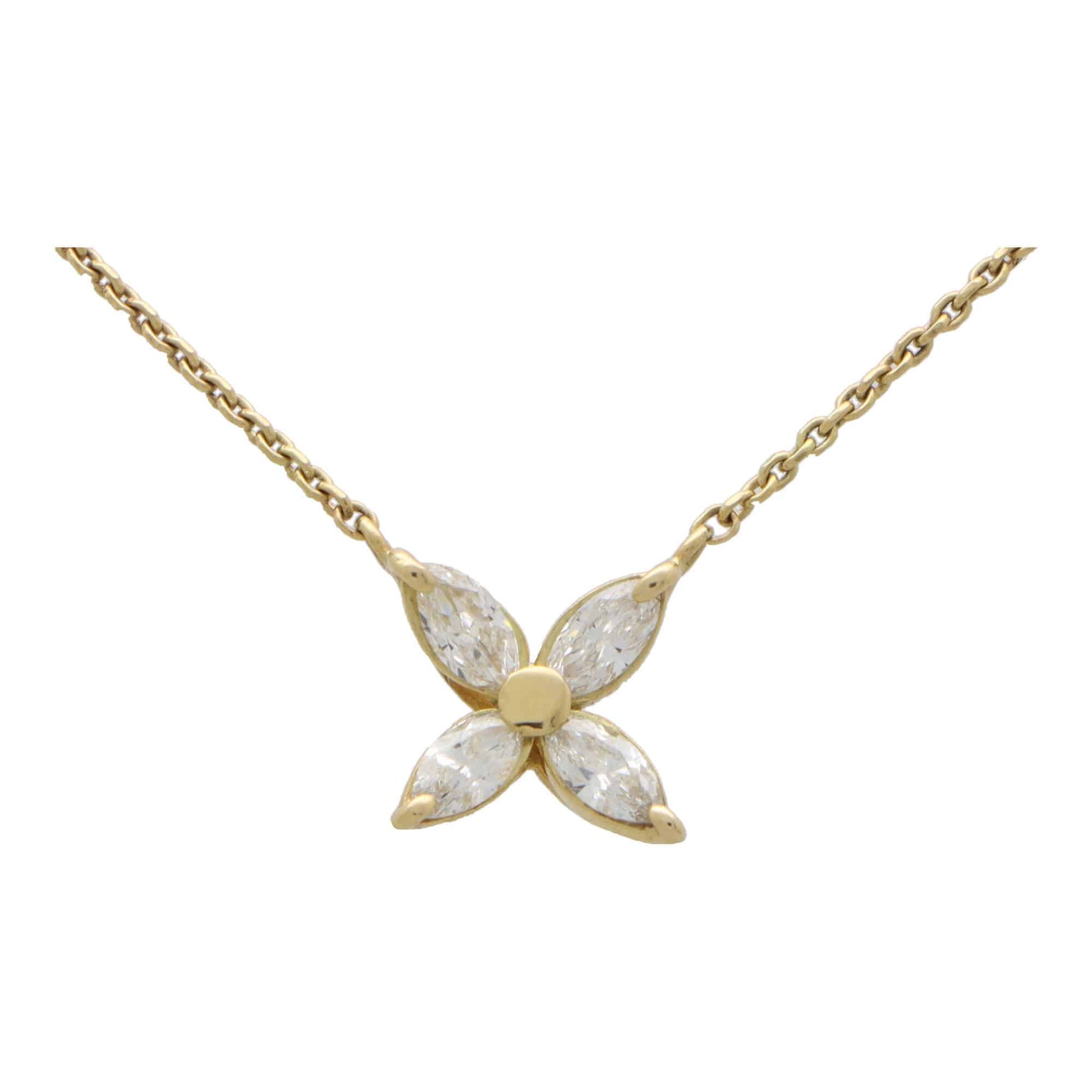 A yellow gold marquise cut diamond pendant necklace, on a white background