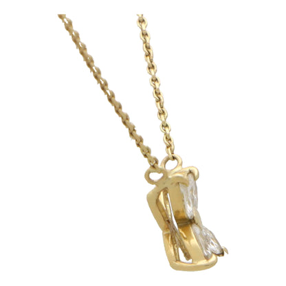 A yellow gold marquise cut diamond pendant necklace, on a white background