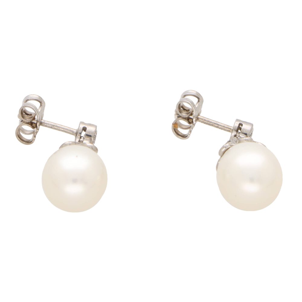 Pearl and diamond drop earrings in white gold.