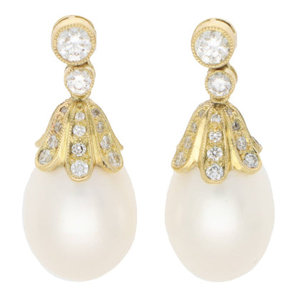 Pearl and diamond drop earrings in yellow gold.