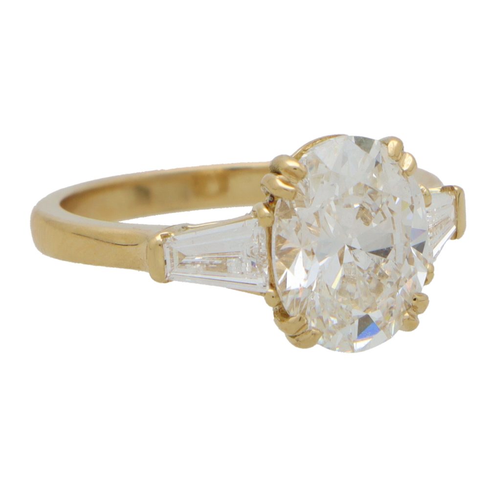 GIA Certified 3ct Oval Cut Diamond Three Stone Ring with tapered baguette shoulders