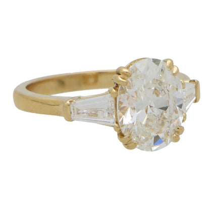 GIA Certified 3ct Oval Cut Diamond Three Stone Ring with tapered baguette shoulders