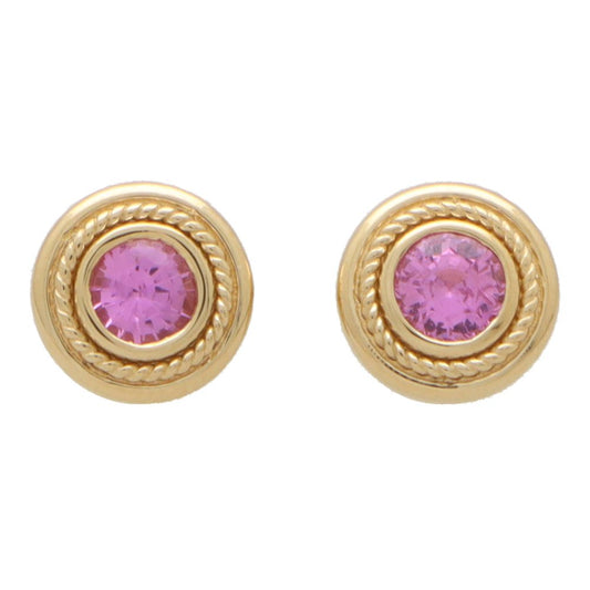 Pink sapphire stud earrings set in yellow gold.