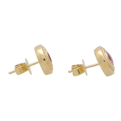 Pink sapphire stud earrings set in yellow gold.
