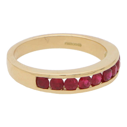 Ruby half eternity ring set in 18 carat yellow gold.