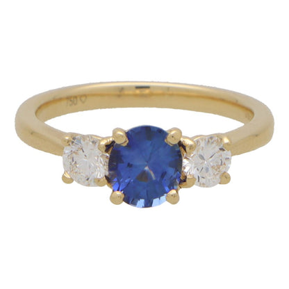 Diamond and sapphire three stone ring in yellow gold.
