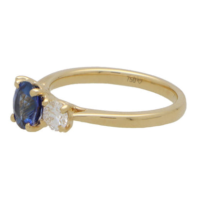 Diamond and sapphire three stone ring in yellow gold.