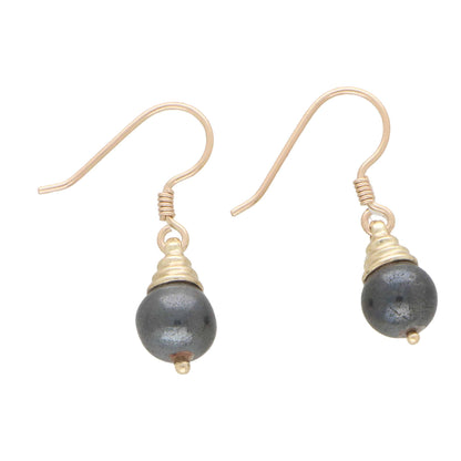 A pair of hematite drop earrings in yellow gold on a white background