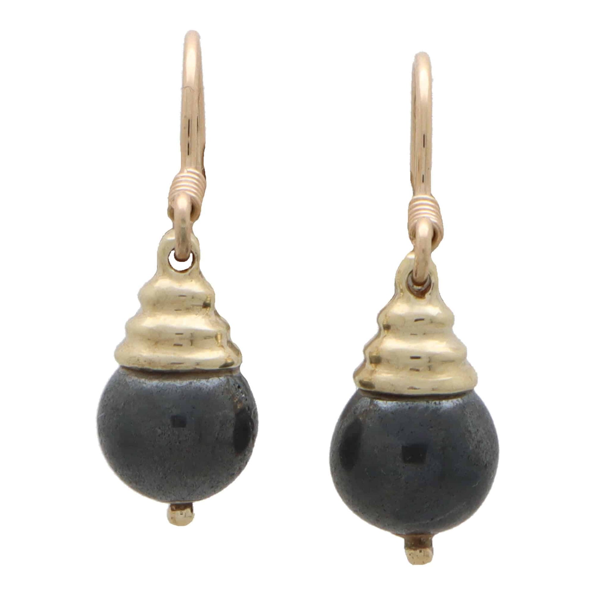 A pair of hematite drop earrings in yellow gold on a white background
