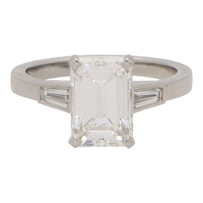 Emerald cut diamond three stone ring set in platinum.