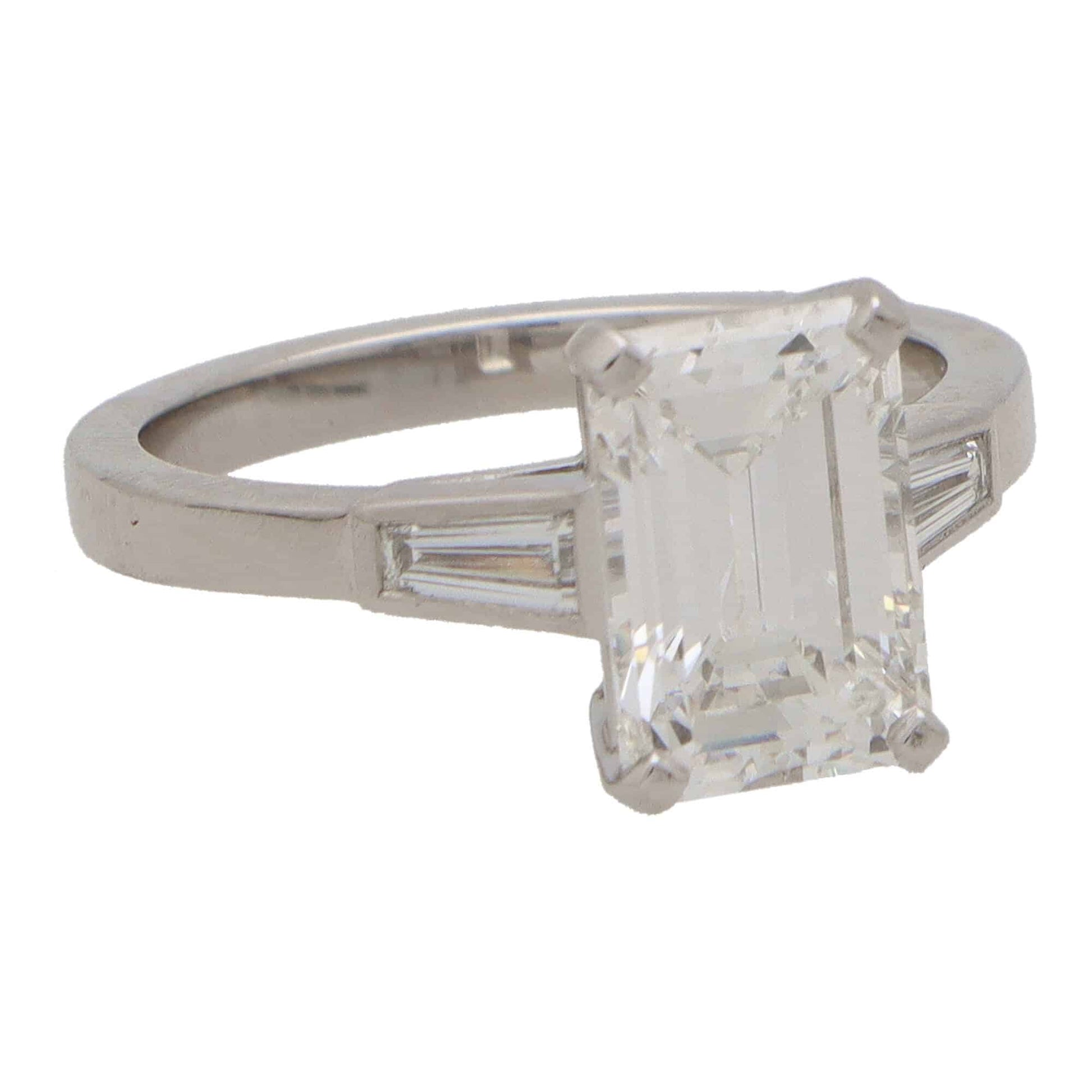 Emerald cut diamond three stone ring set in platinum.