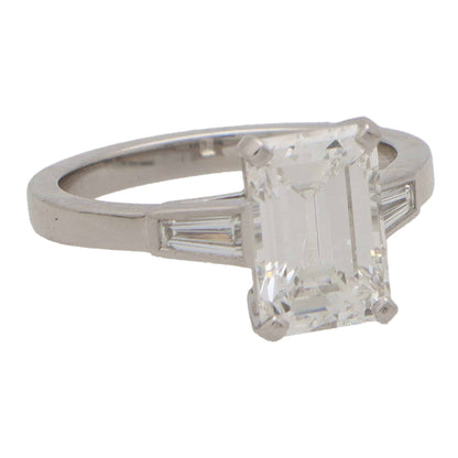 Emerald cut diamond three stone ring set in platinum.