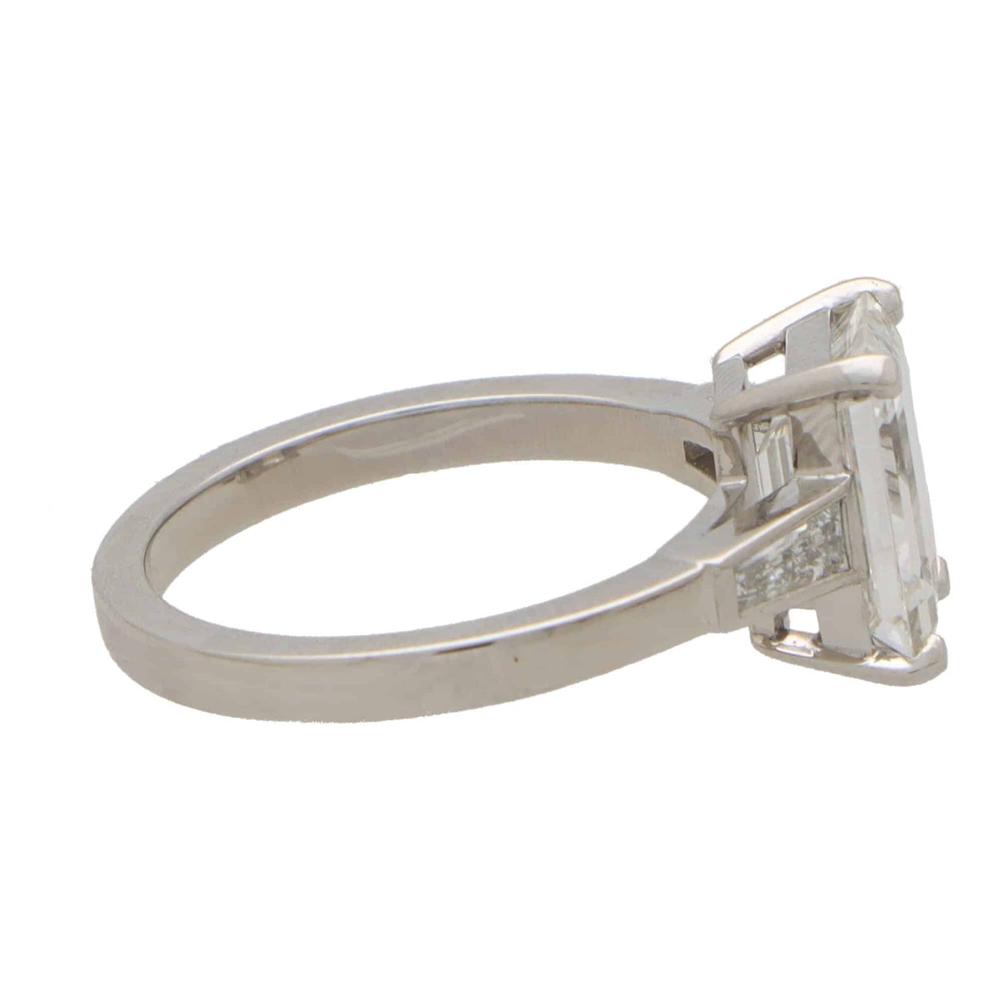 Emerald cut diamond three stone ring set in platinum.