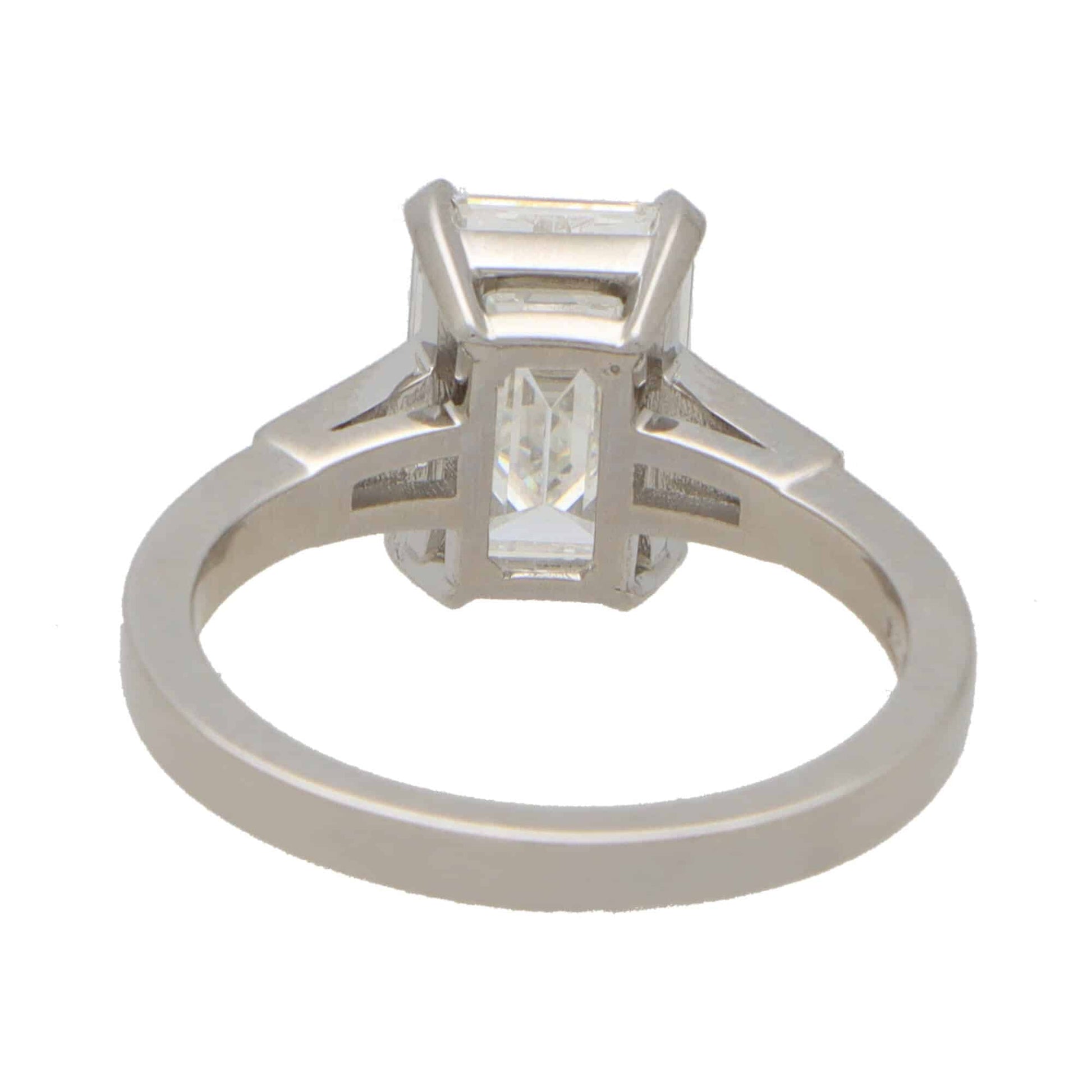 Emerald cut diamond three stone ring set in platinum.