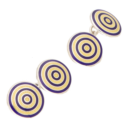 A pair of circular blue and yellow enamel cufflinks in silver, on a white background