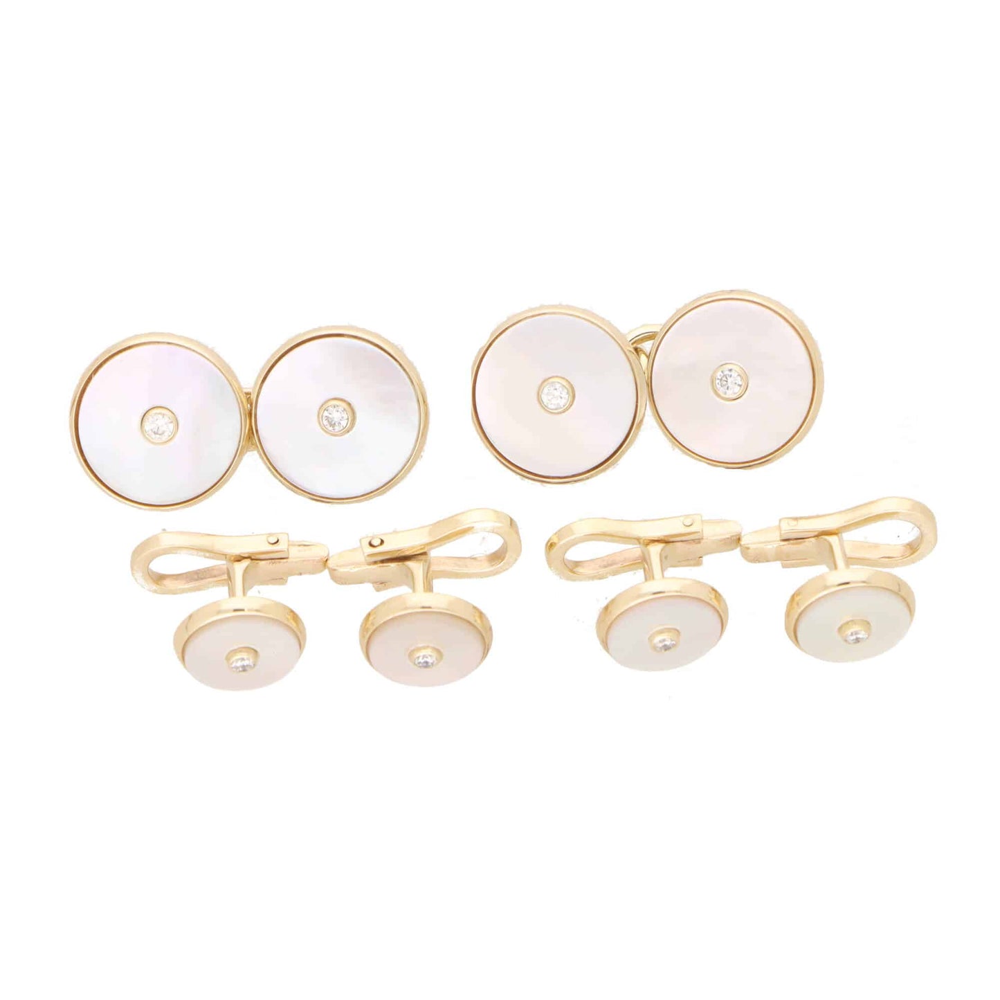 A pair of mother-of-pearl and diamond cufflinks in yellow gold with matching shirt studs, on a white background