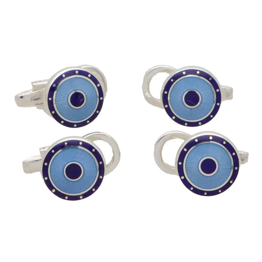 Four circular shirt studs with blue enamel faces, in a white background