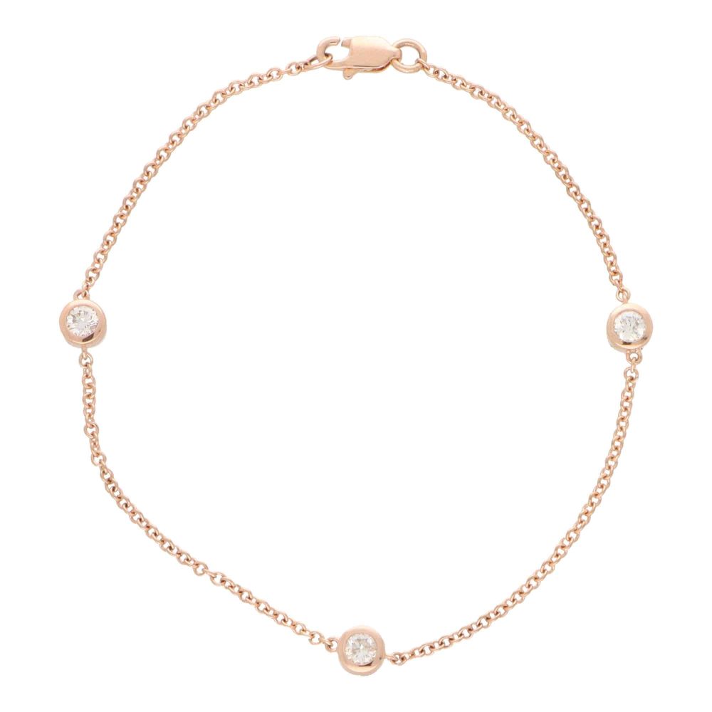 Diamond three stone chain link bracelet in rose gold.