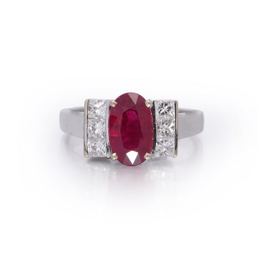 2.15ct Oval Ruby and Princess Cut Diamond Engagement Ring, vibrant oval mixed-cut natural ruby flanked by a row of vertically set square princess-cut diamonds to each side in 18ct white gold
