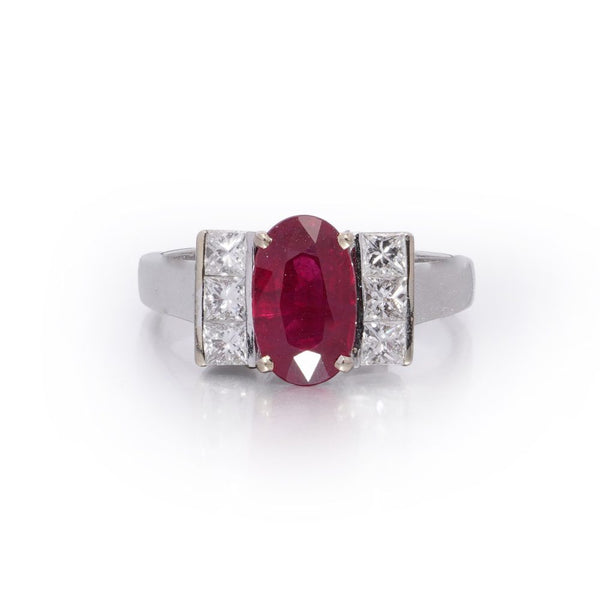 2.15ct Oval Ruby and Princess Cut Diamond Engagement Ring, vibrant oval mixed-cut natural ruby flanked by a row of vertically set square princess-cut diamonds to each side in 18ct white gold