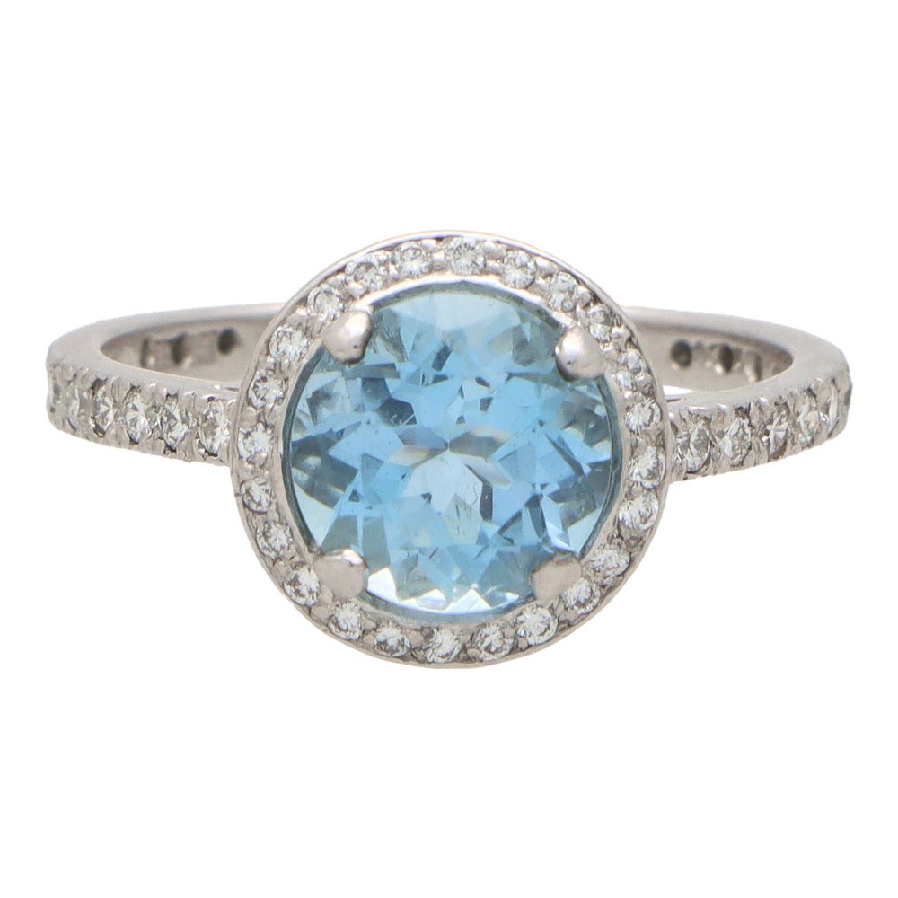 Aquamarine and diamond halo ring set in platinum.