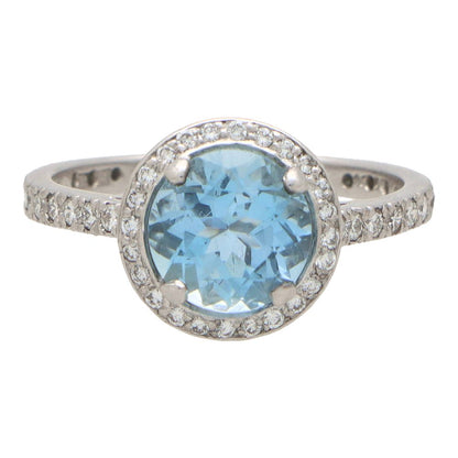 Aquamarine and diamond halo ring set in platinum.