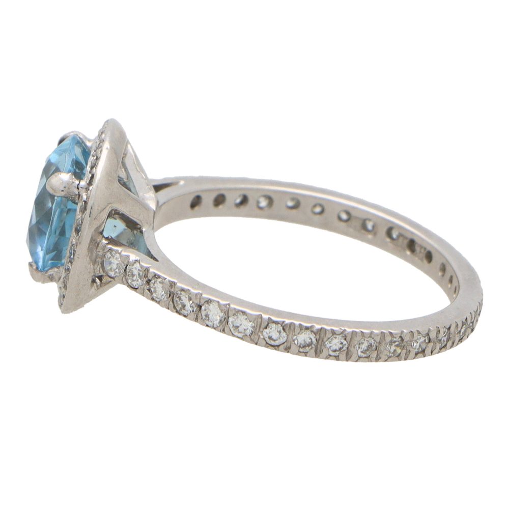Aquamarine and diamond halo ring set in platinum.