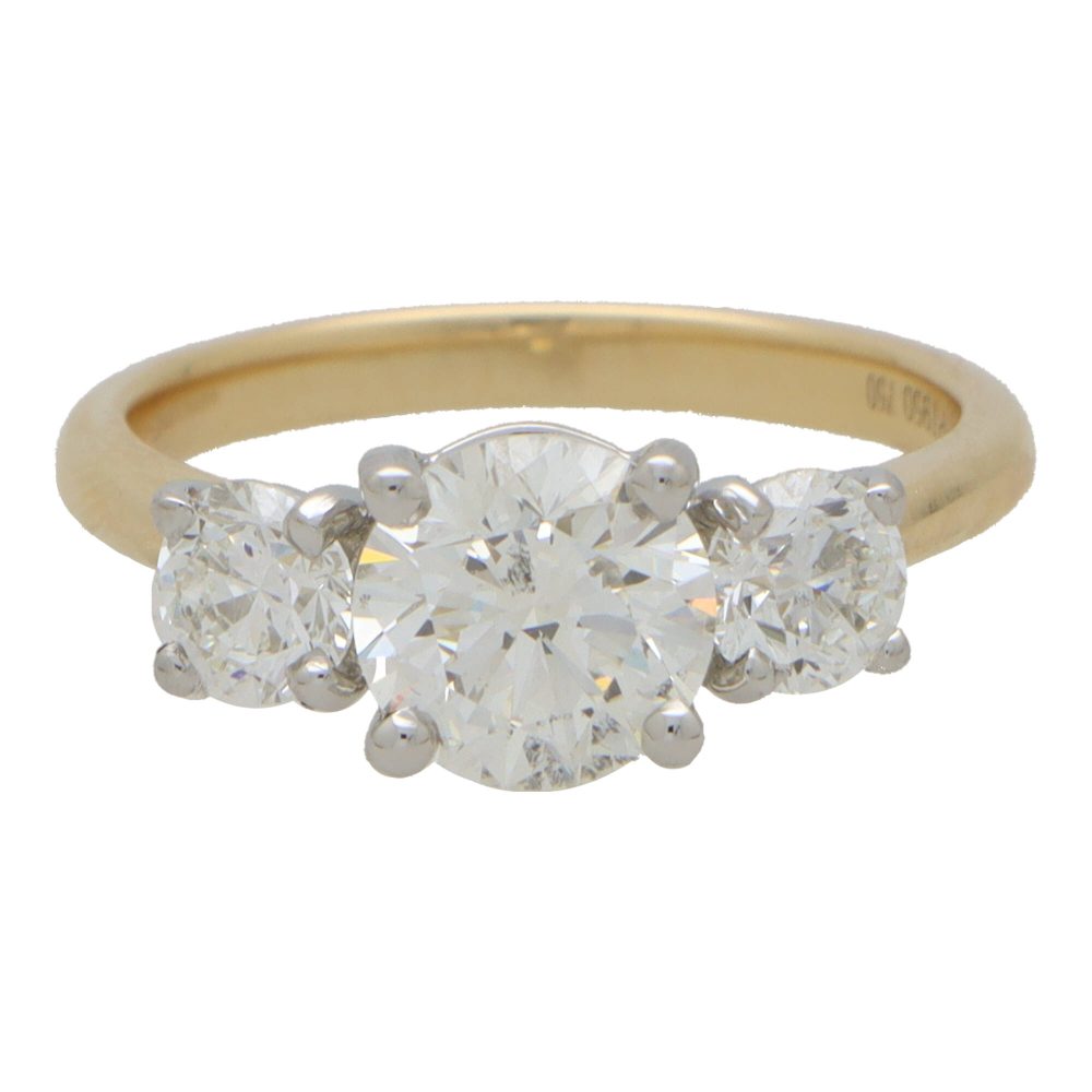 Diamond three stone engagement ring in yellow and white gold.