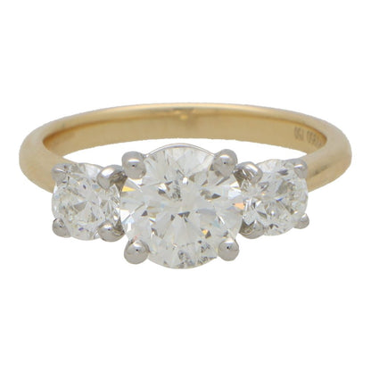 Diamond three stone engagement ring in yellow and white gold.