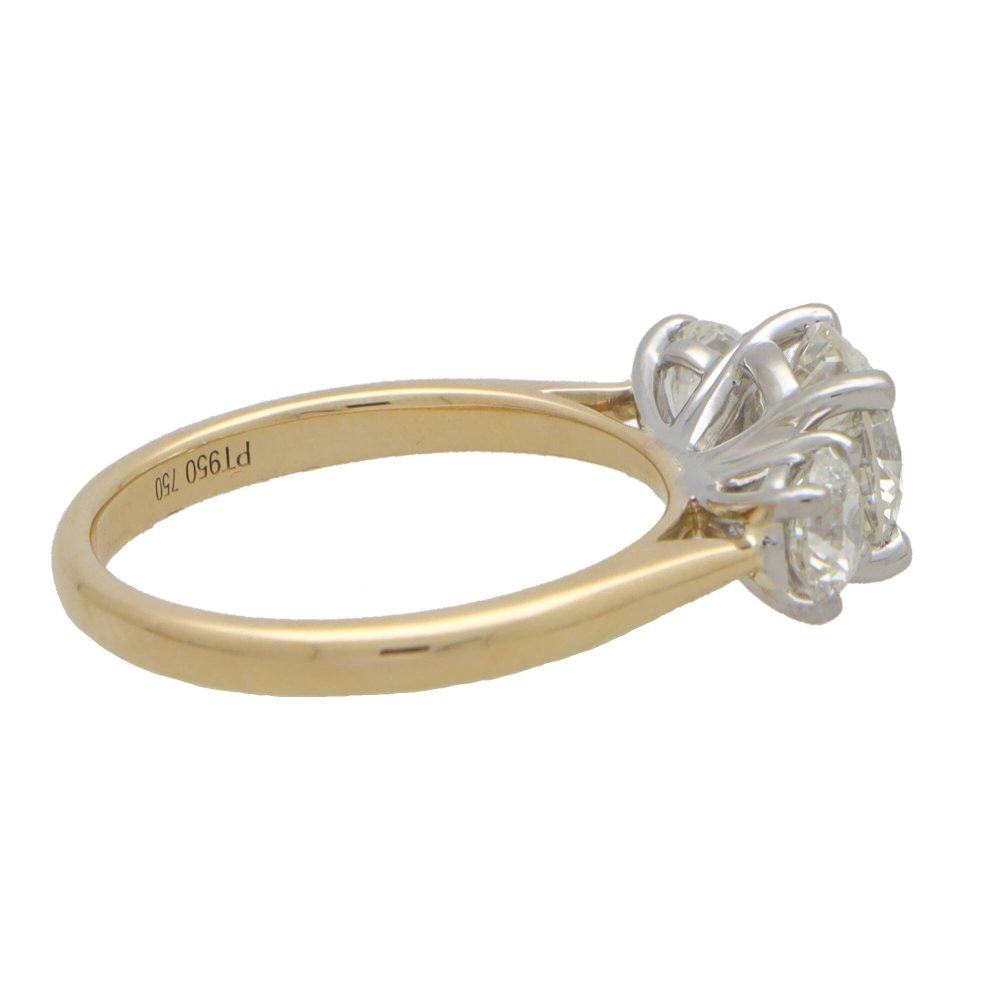 Diamond three stone engagement ring in yellow and white gold.
