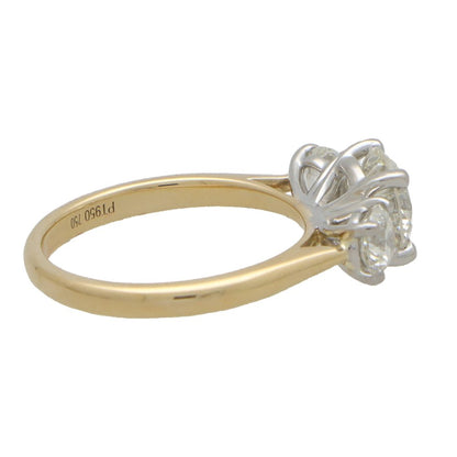 Diamond three stone engagement ring in yellow and white gold.